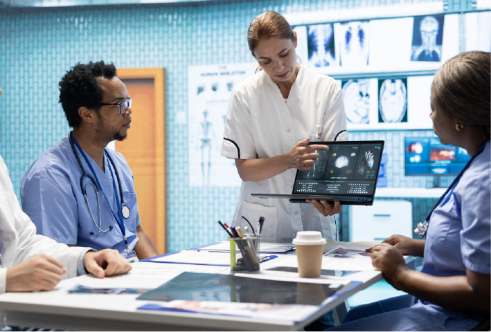 Team of specialists reviewing ecg results in a meeting at a private clinic, analyzing cardiovascular system on a radiography for disease prevention. Consulting cardiac scans and records.