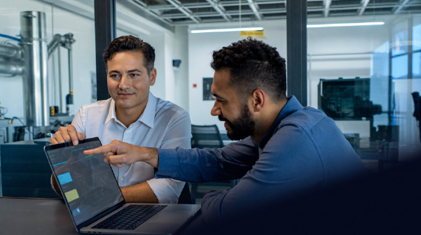 Two people looking at a computer